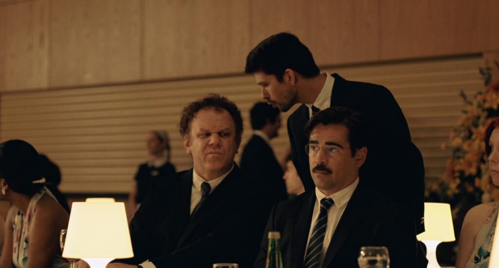 Colin Farrell. John C Reilly and Ben Whishaw wearing suits at an upscale function.