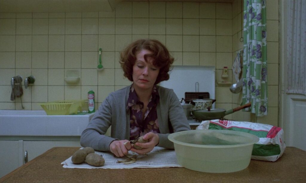 Delphine Seyrig peeling potatoes in Jeanne Dielman, 23 quai du Commerce, 1080 Bruxelles